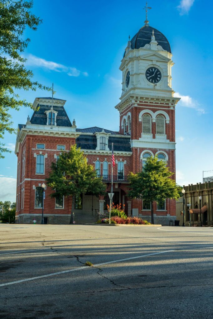 Historic Newton County Courthouse in Covington GA featuring the iconic clock tower and the charming downtown square known for its Southern character.
